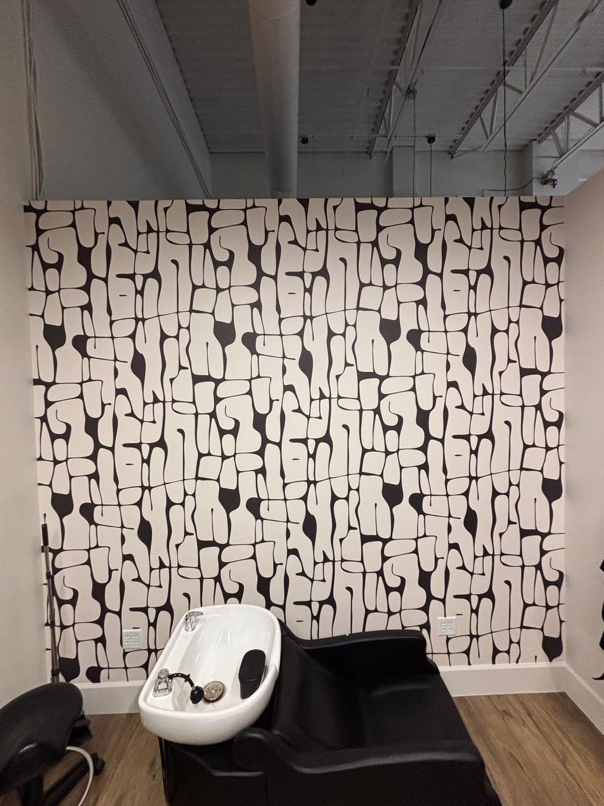 Black and white patterned wallpaper in a salon space