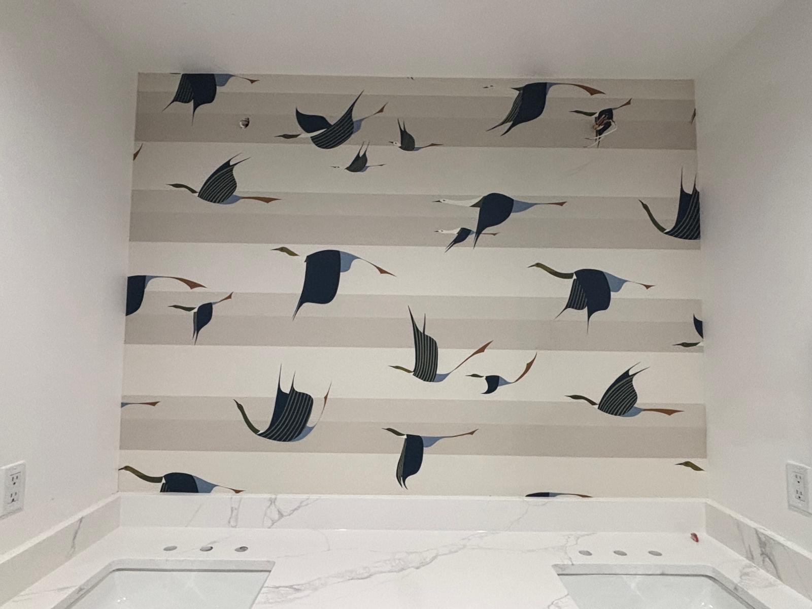 Bird pattern wallpaper above a bathroom vanity