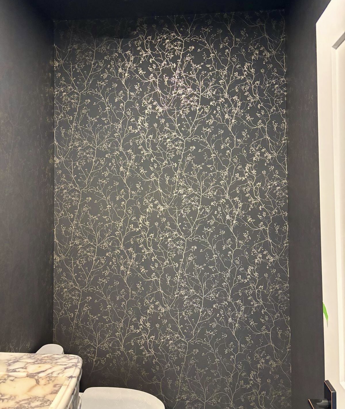 Dark floral wallpaper in a bathroom